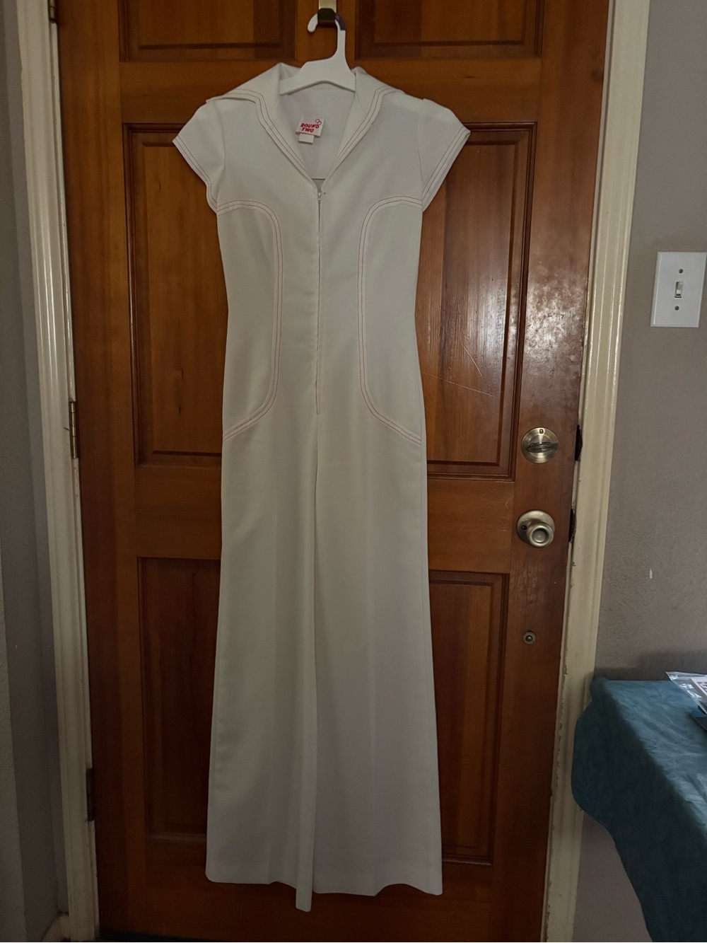 Vintage women's white jumpsuit with red stitching. Cleaned up with no stains